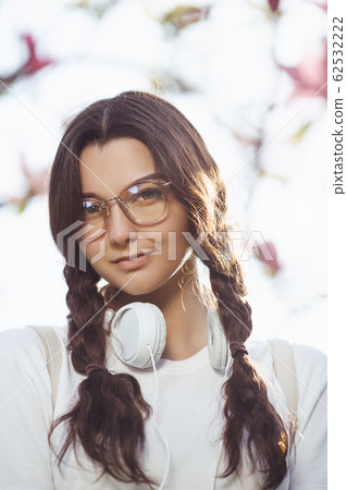Woman With Headphones Outdoors in the City Park Woman With Headphones Outdoors in the City Park 62532222