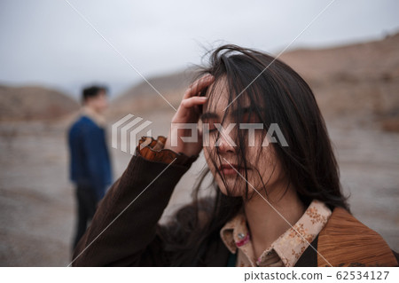 Dramatic portrait of a young brunette girl in 62534127