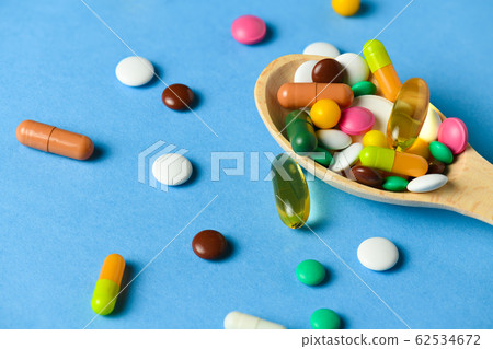 Wooden spoon full of pills, tablets, vitamins, Wooden spoon full of pills, tablets, vitamins, 62534672