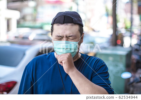 Asian man wear medical mask on the street Asian man wear medical mask on the street 62534944