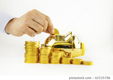 A person putting gold coins into a piggy bank A person putting gold coins into a piggy bank 62535786