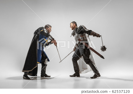 Brave armored knights fighting isolated on white studio background 62537120