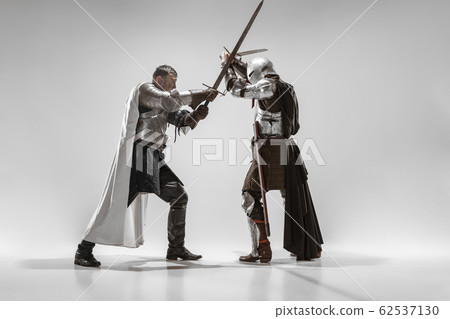 Brave armored knights fighting isolated on white studio background Brave armored knights fighting isolated on white studio background 62537130