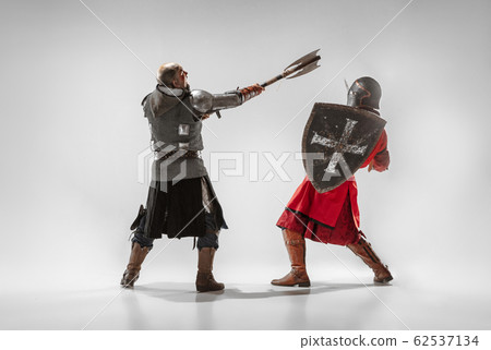 Brave armored knights fighting isolated on white studio background Brave armored knights fighting isolated on white studio background 62537134