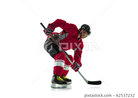 Male hockey player with the stick on ice court and white background Male hockey player with the stick on ice court and white background 62537232