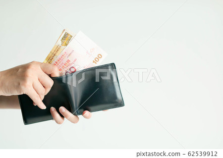 Hands picking Hong Kong money (Dollar Hong Kong or HKD) from short wallet for payment. or Hands picking Hong Kong money (Dollar Hong Kong or HKD) from short wallet for payment. or 62539912