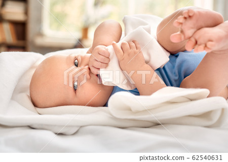 Little newborn baby cover in blanket, looking at camera Little newborn baby cover in blanket, looking at camera 62540631