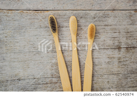 Zero waste concept. Bamboo toothbrush on wooden background. Plastic free essentials, teeth care 62540974