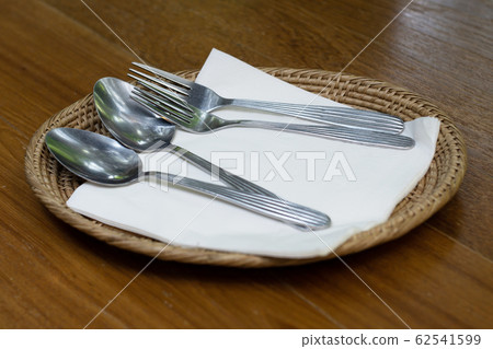 stainless steel fork and spoon on white cloth stainless steel fork and spoon on white cloth 62541599
