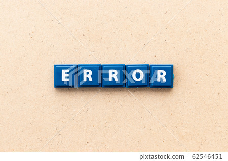 Tile letter in word error on wood background 62546451