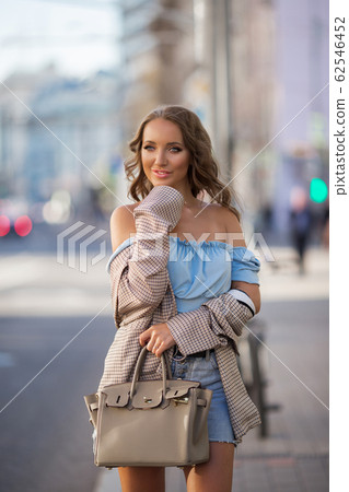 Beautiful young woman wearing stylish clothes walking on the street 62546452