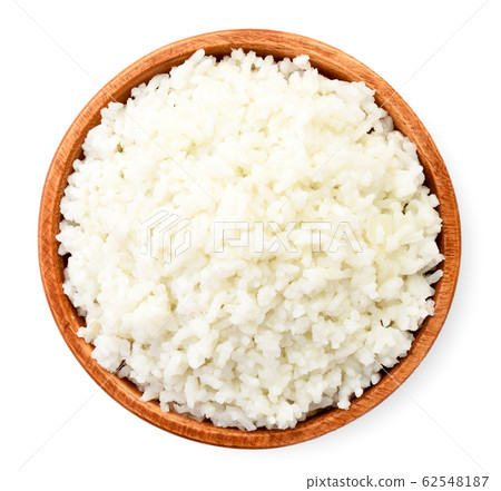 Cooked rice in a wooden plate on a white. The view Cooked rice in a wooden plate on a white. The view 62548187