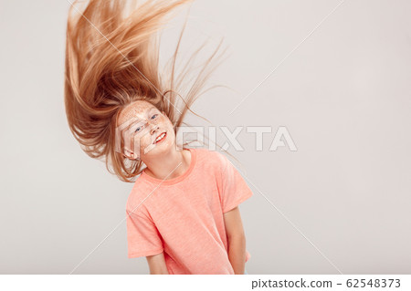 Inclusive Beauty. Girl with freckles standing isolated on grey shaking head smiling playful Inclusive Beauty. Girl with freckles standing isolated on grey shaking head smiling playful 62548373
