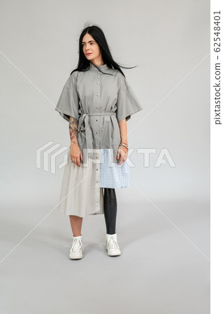Freestyle. Diverse girl with leg prosthesis standing isolated on grey full body shot inspired wind blow Freestyle. Diverse girl with leg prosthesis standing isolated on grey full body shot inspired wind blow 62548401