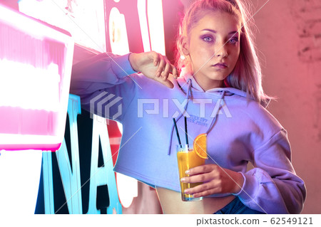Teenage girl in night club with neon light Teenage girl in night club with neon light 62549121