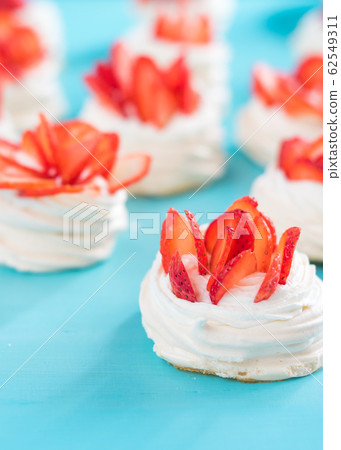 pavlova meringue nests with strawberry cream and fresh strawberries 62549311