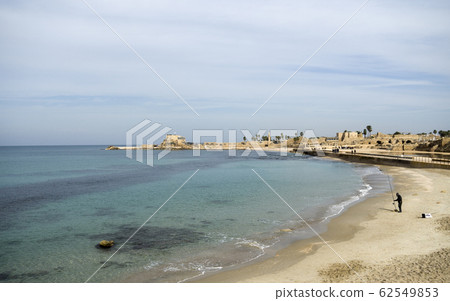 Caesara, Israel - view on fisherman in bay, and port in distance Caesara, Israel - view on fisherman in bay, and port in distance 62549853