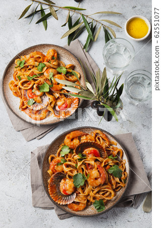 Seafood Spaghetti with seashells, prawns, squids on gray background. Italian mediterranean food 62551077