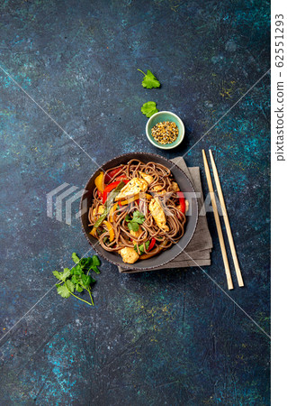 Japanese dish buckwheat soba noodles with chicken and vegetables carrot, bell pepper and green beans Japanese dish buckwheat soba noodles with chicken and vegetables carrot, bell pepper and green beans 62551293