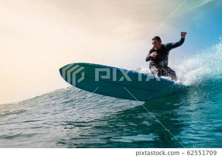 Surfer riding waves on the island of fuerteventura 62551709