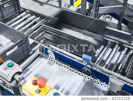Modern conveyor system with box in motion. 62551729
