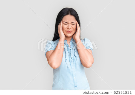 Freestyle. Asian woman standing isolated on white having headache irritated Freestyle. Asian woman standing isolated on white having headache irritated 62551831