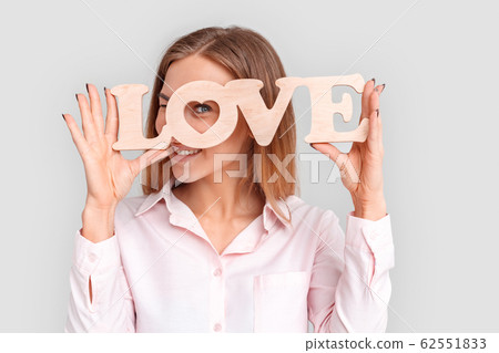 Freestyle. Young woman standing isolated on white with love sign looking through heart smiling happy close-up Freestyle. Young woman standing isolated on white with love sign looking through heart smiling happy close-up 62551833