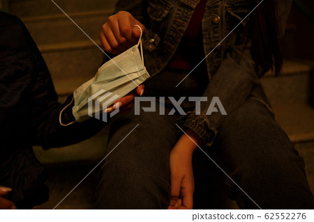 medical disposable mask in the hands of young 62552276