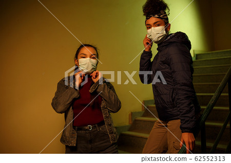 young Asian and African girl in disposable medical young Asian and African girl in disposable medical 62552313