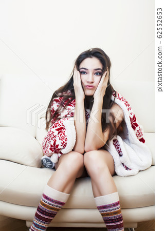 young pretty brunette girl in Christmas ornament blanket getting warm on cold winter, freshness beauty concept 62552653