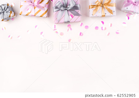 Set of gift boxes with bows and confetti on a white background. 62552905