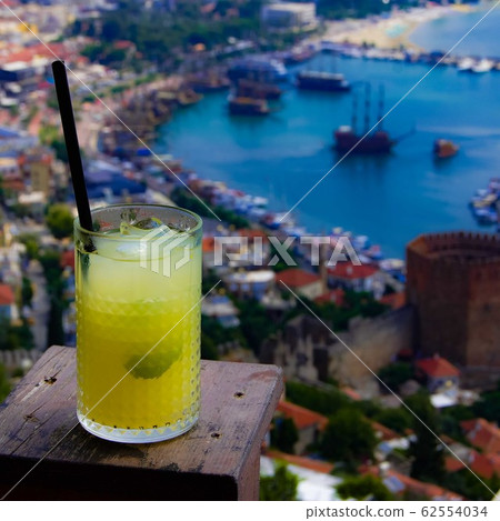 Glass of lemonade with sea harbour background 62554034