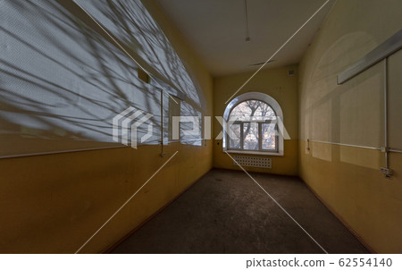 Shadows from the branches on the wall of the empty 62554140