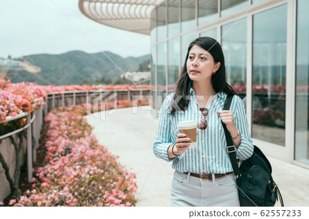 woman with takeaway coffee walk outdoor corridor 62557233
