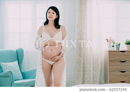 young woman wearing beige robe walking young woman wearing beige robe walking 62557245