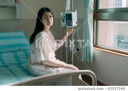 Saline in hands of female patient. Saline in hands of female patient. 62557249