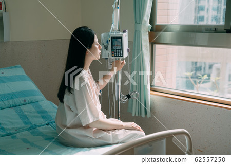 loneliness sick woman on bed in hospital room loneliness sick woman on bed in hospital room 62557250