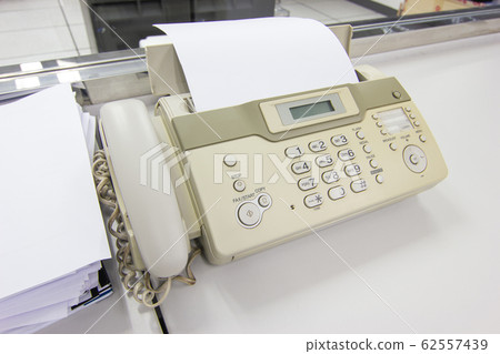 Hand man are using a fax machine in the office, Business concept office life Hand man are using a fax machine in the office, Business concept office life 62557439