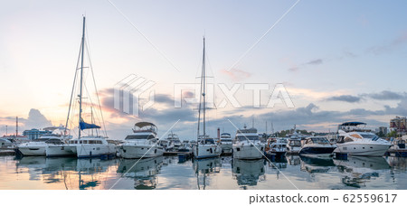 Beautiful sunset in the sea harbor with moored yachts. 62559617