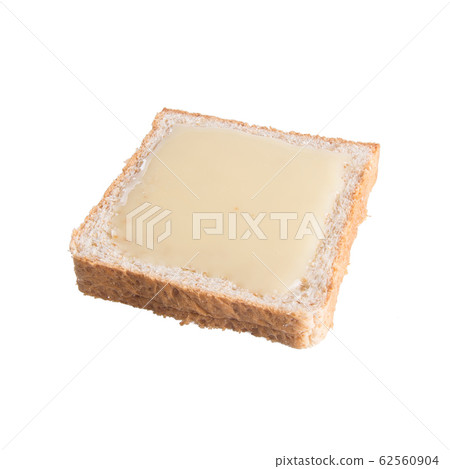 bread with condensed milk on a background new. bread with condensed milk on a background new. 62560904