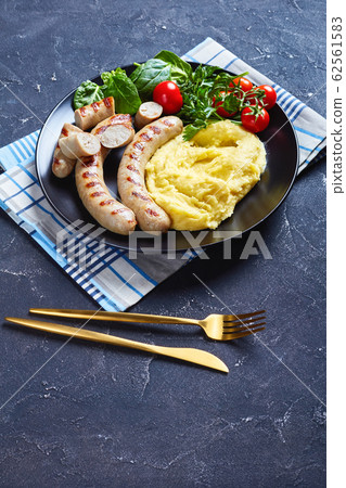 French potato aligot with sausage and fresh salad French potato aligot with sausage and fresh salad 62561583