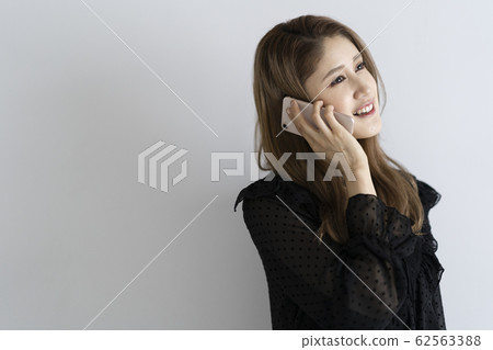 A woman using a mobile phone 62563388