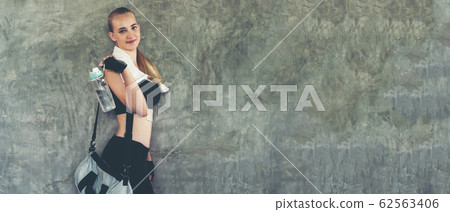 Healthy lifestyle woman drink water at fitness  62563406