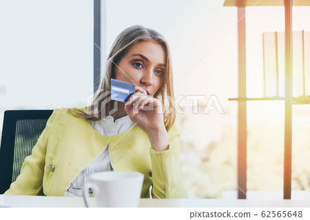 Business woman holding credit card payment in a 62565648
