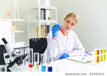 Young female scientist doing some research working Young female scientist doing some research working 62565652