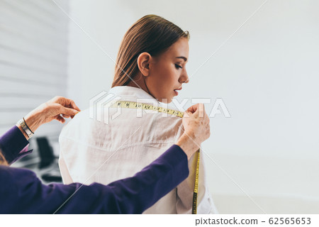 Fashion designer studio measuring textile material Fashion designer studio measuring textile material 62565653