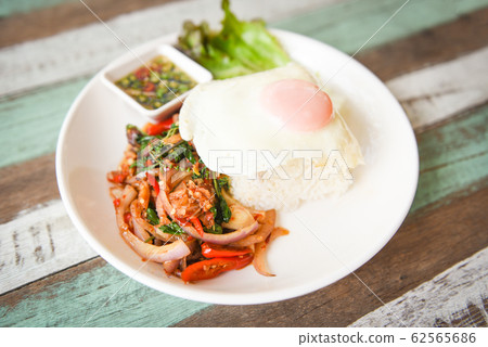 Rice topped with stir fried pork beef meat with 62565686