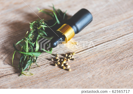 Marijuana seeds with CBD oil bottle and marijuana Marijuana seeds with CBD oil bottle and marijuana 62565717