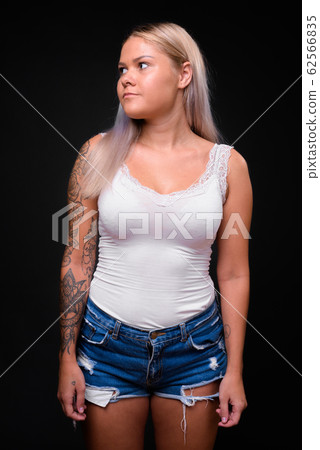 Young beautiful blonde woman against black background 62566835