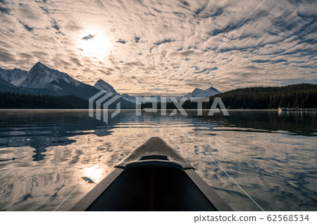 Canoeing with Canadian Rockies and sunlight cloudy Canoeing with Canadian Rockies and sunlight cloudy 62568534